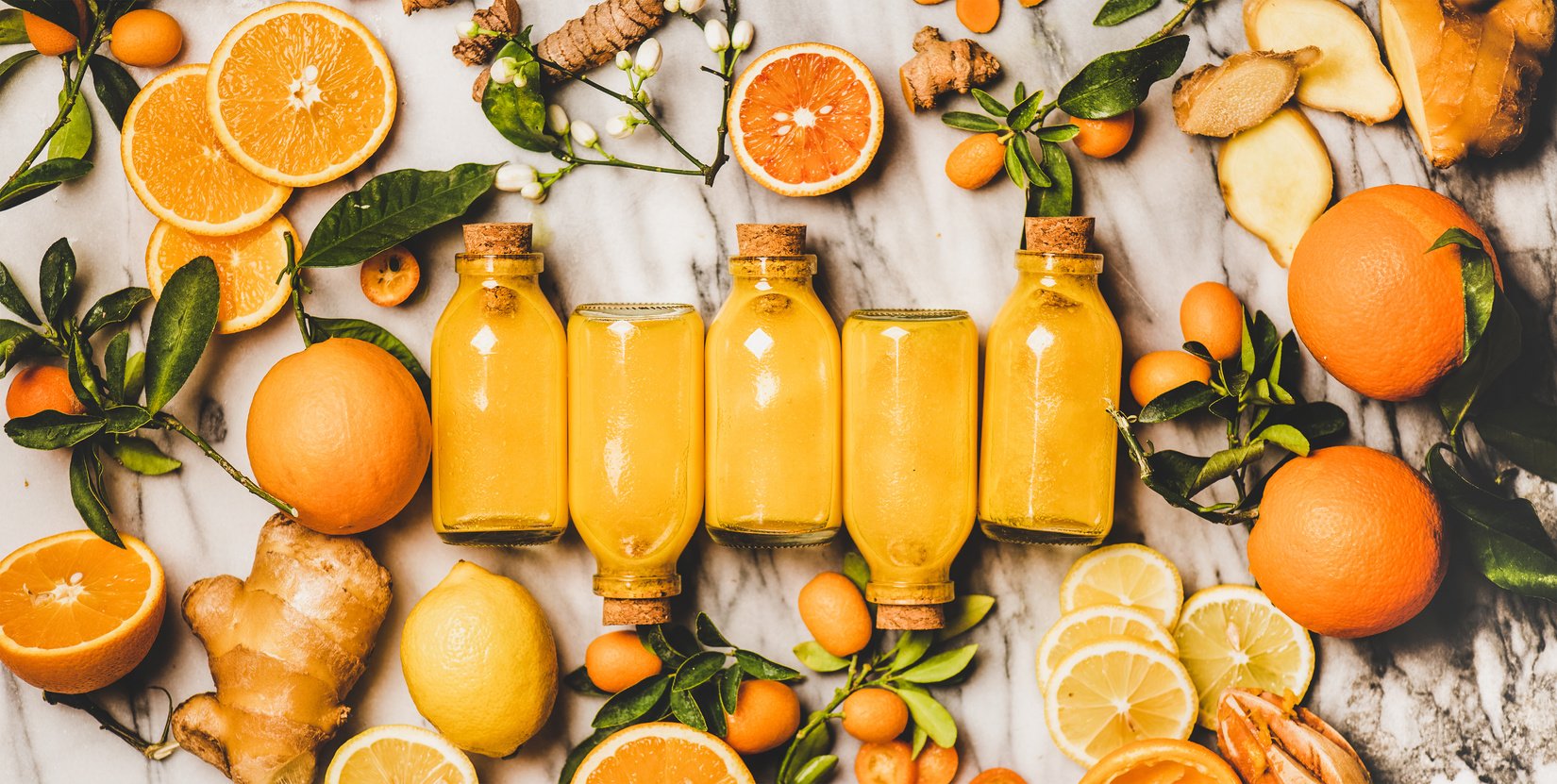 Immune boosting turmeric, ginger, citrus juice shot in bottles